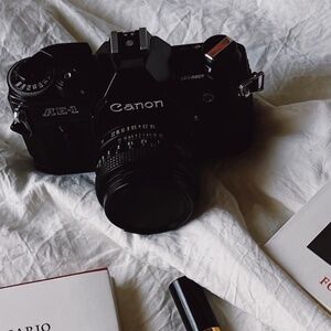 Black Canon AE-1 Program 35mm SLR Camera with 50mm 1:1.8 Lens